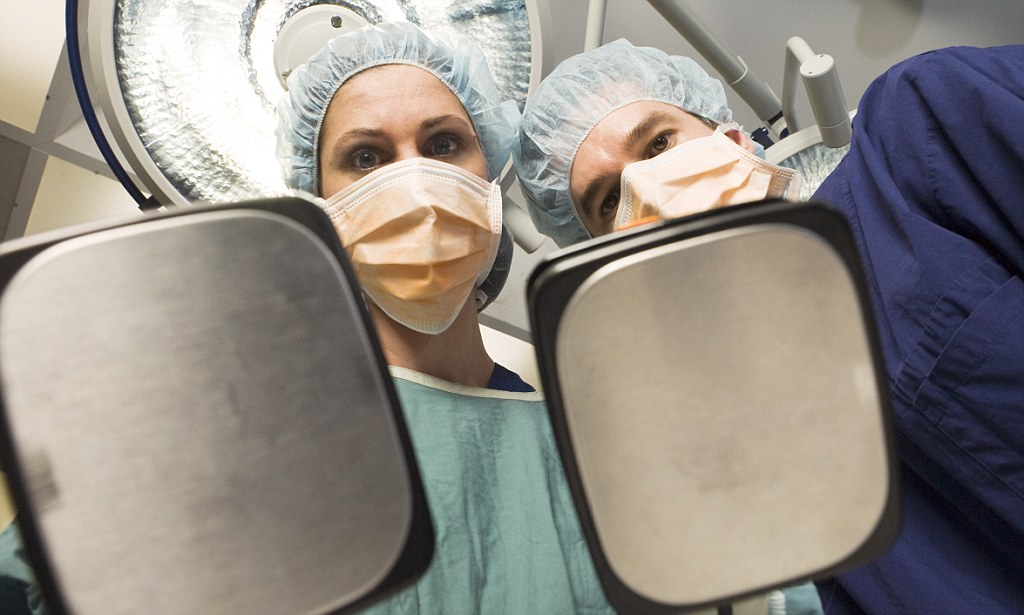 Surgeons Using Defibrillator